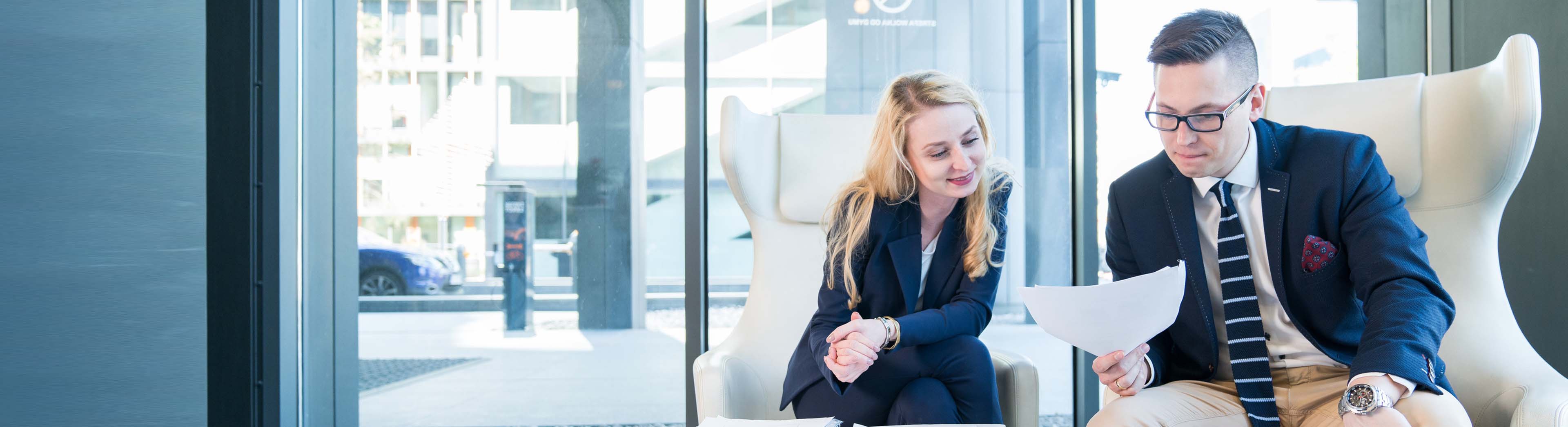 Two colleagues a woman and a man discussing details for a proposal